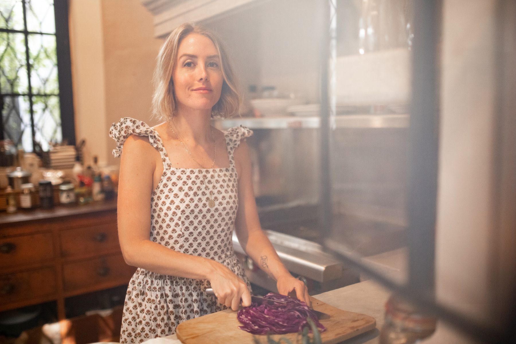 Dr. Nancy Crowell in her kitchen, slicing purple cabbage